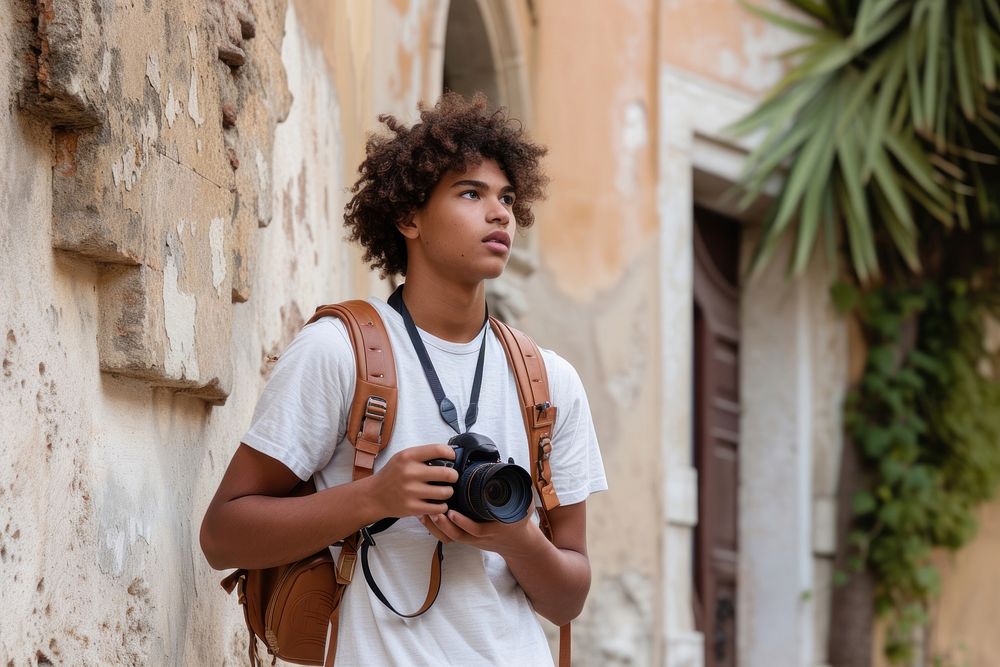 Mixed race teen man outdoors camera travel.