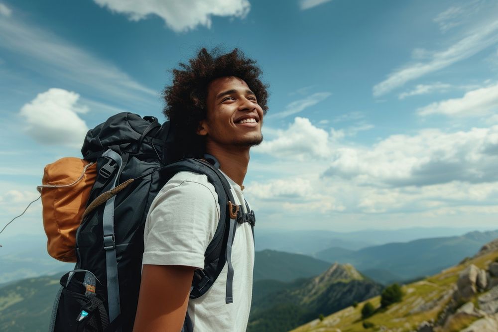 Mixed race teen man backpack backpacking mountain.