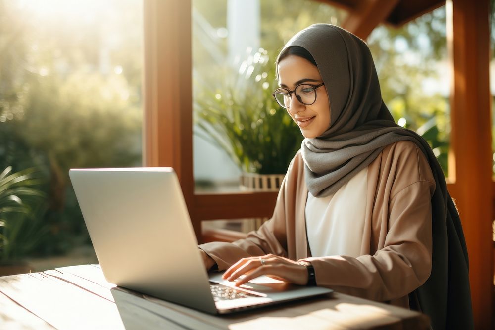 Muslim woman laptop computer typing.