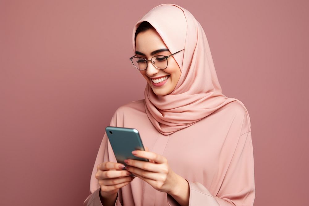 Muslim woman glasses hijab photographing.