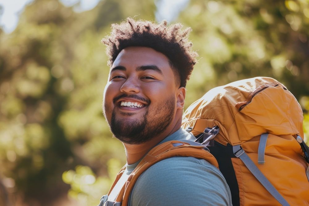 Plus size mixed race teen outdoors backpack smiling.
