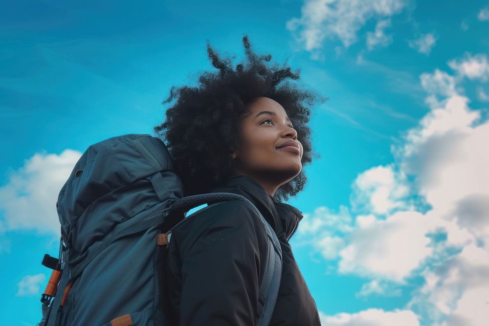 Plus size mixed race woman backpack outdoors looking.