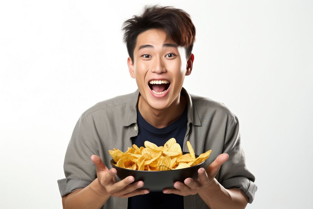 A man holding plate of chips and biting snack eating food white background. AI generated Image by rawpixel.