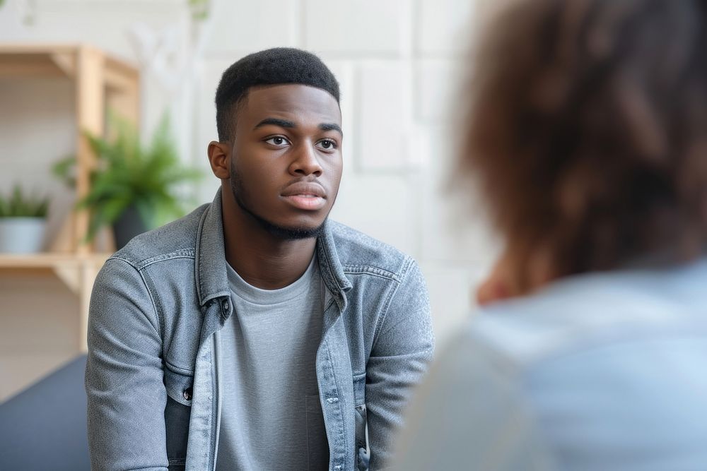Unhappy young black man conversation adult men.