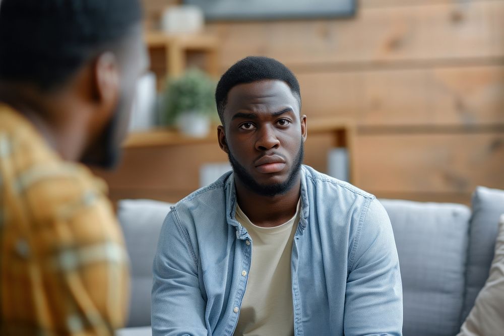 Unhappy young black man conversation adult men.