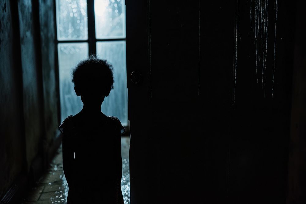 Young black kids silhouette sadness light door.