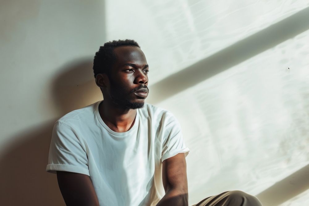 Black man in anxiety portrait worried sitting.