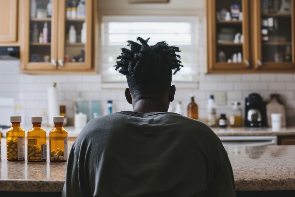 African American young man kitchen adult dreadlocks.