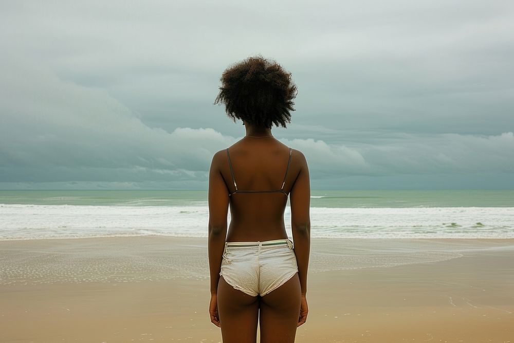 African American young woman beach swimwear standing.