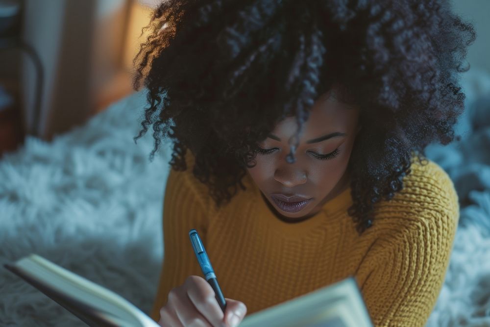 Black woman writing reading adult.