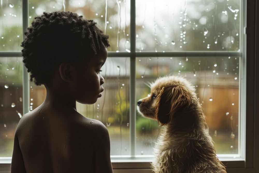 Black kid with dog window photography standing.