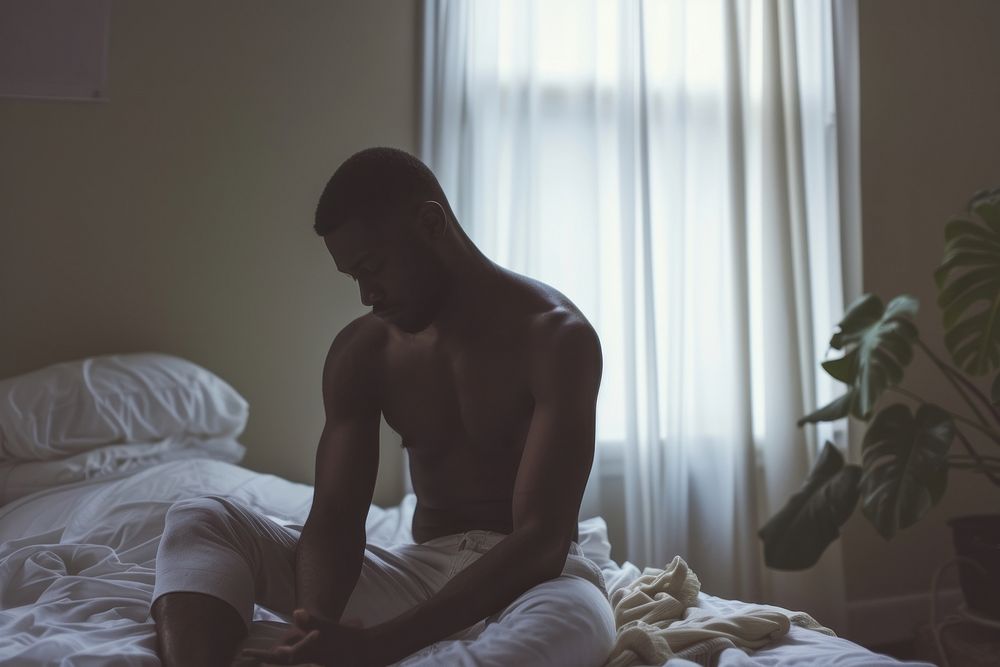 Black man bedroom adult contemplation.