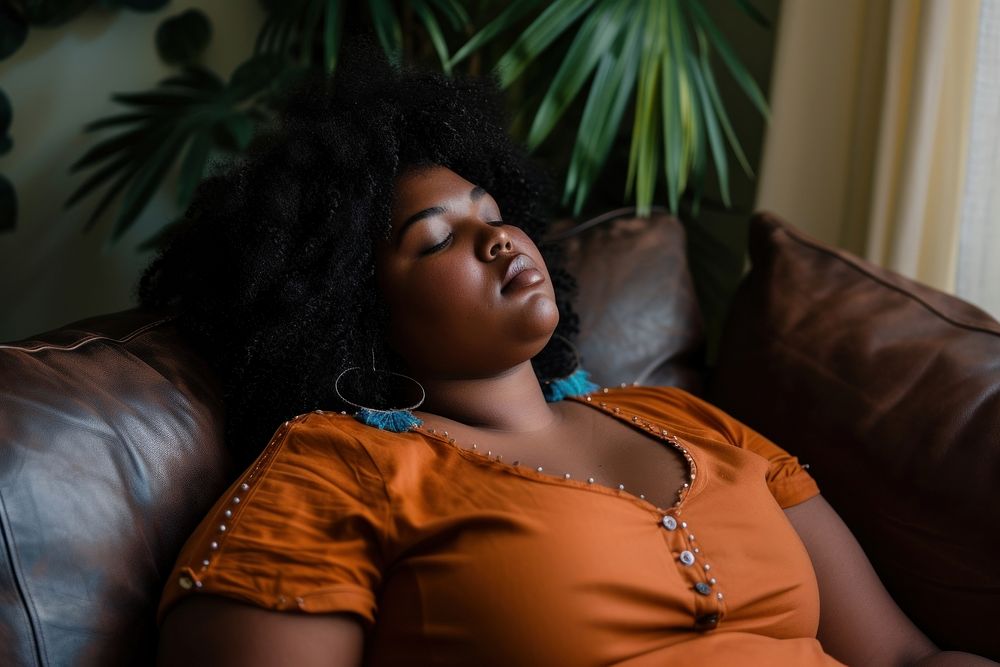 Depressed black chubby woman adult sofa contemplation.