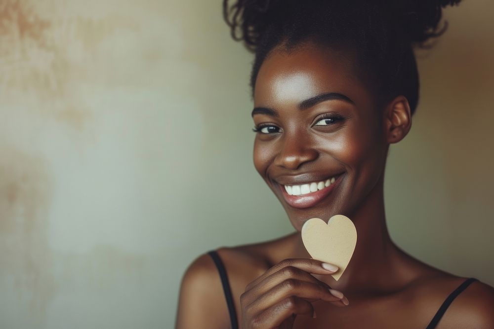 Smiling black woman holding adult smile.