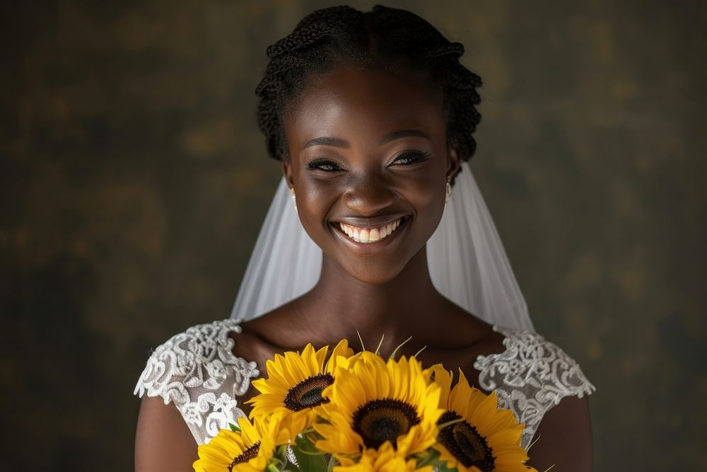 African woman in wedding dress holds a bouquet of sunflowers portrait smiling bride.