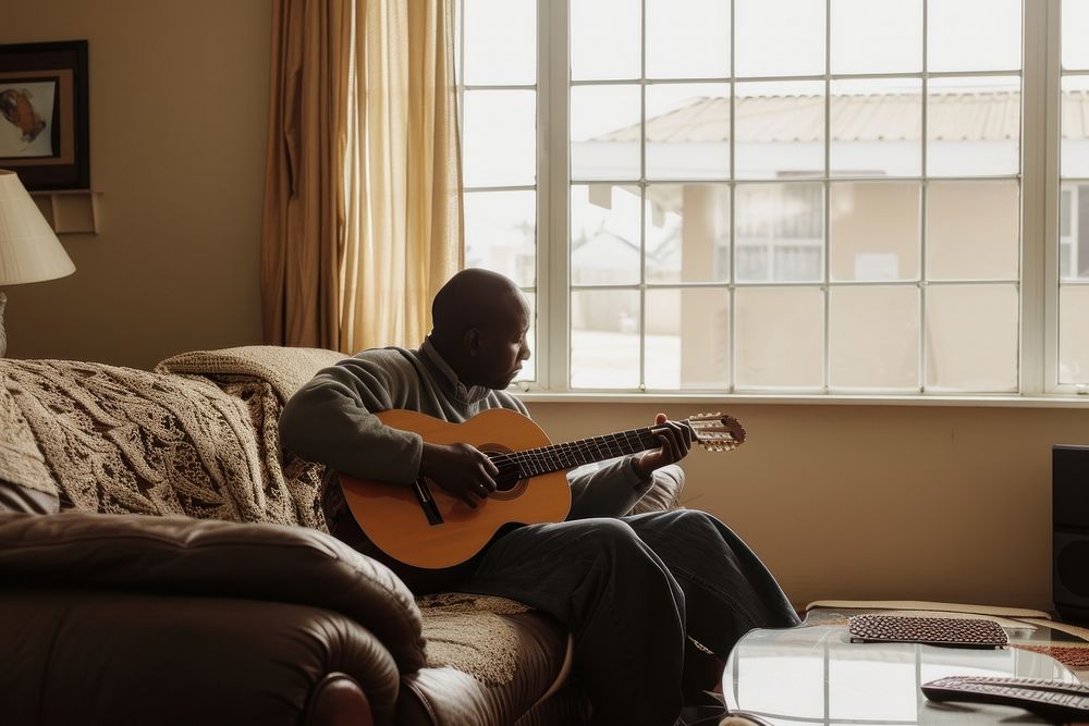 Black South African man guitar furniture musician.
