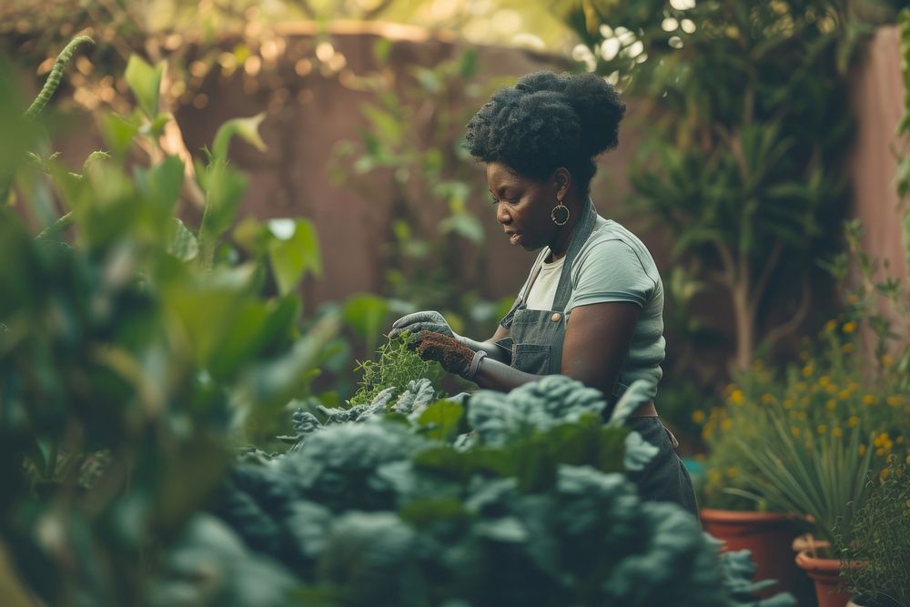 Black South African woman gardening outdoors nature.
