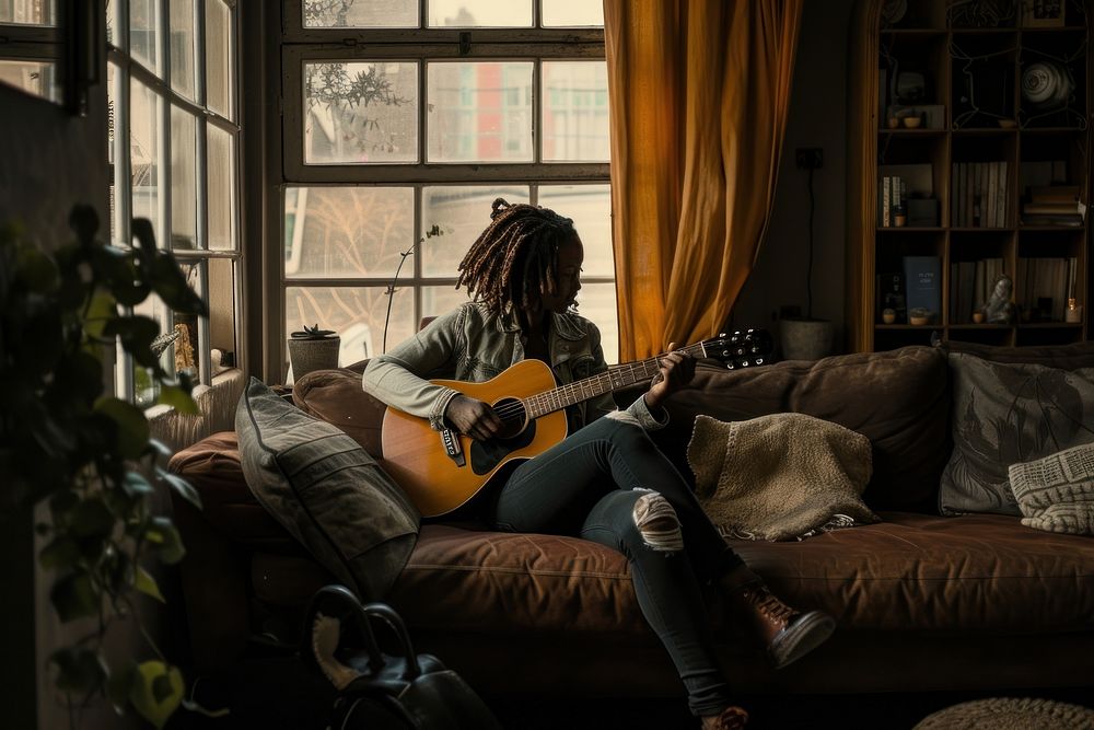 Black South African woman guitar furniture musician.