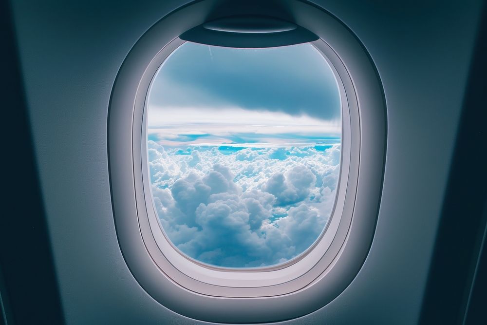 Large window see raining cloudscape airplane aircraft porthole.