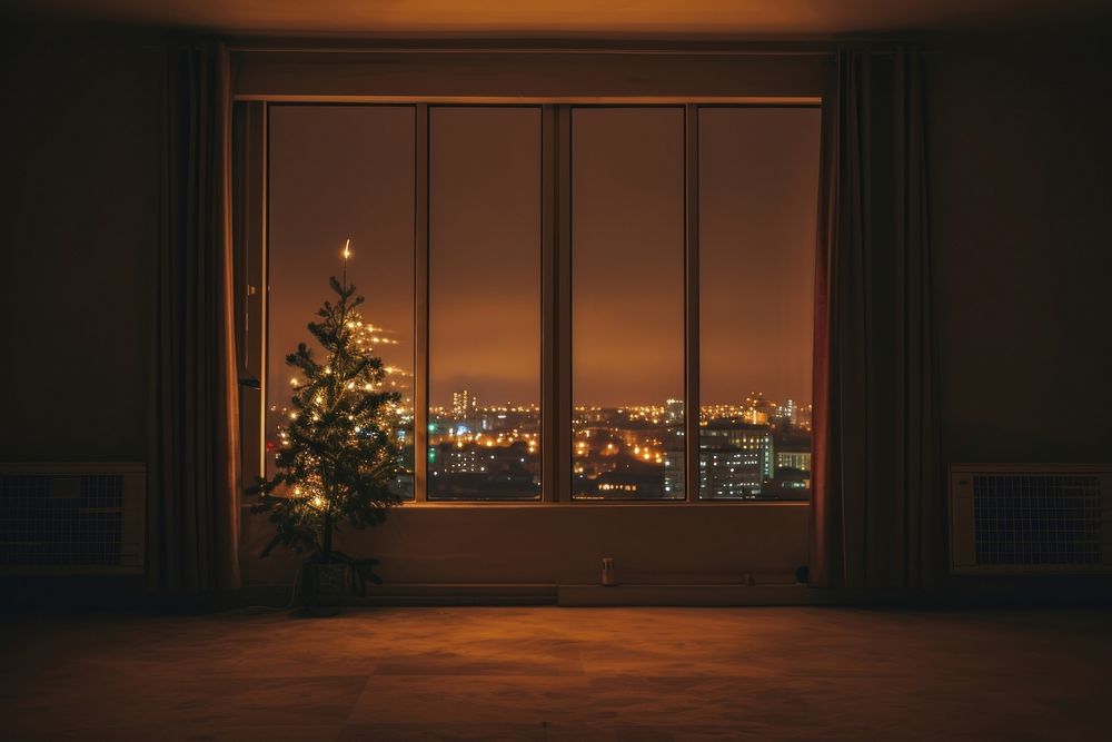 Large window see city in christmas night lighting architecture illuminated.