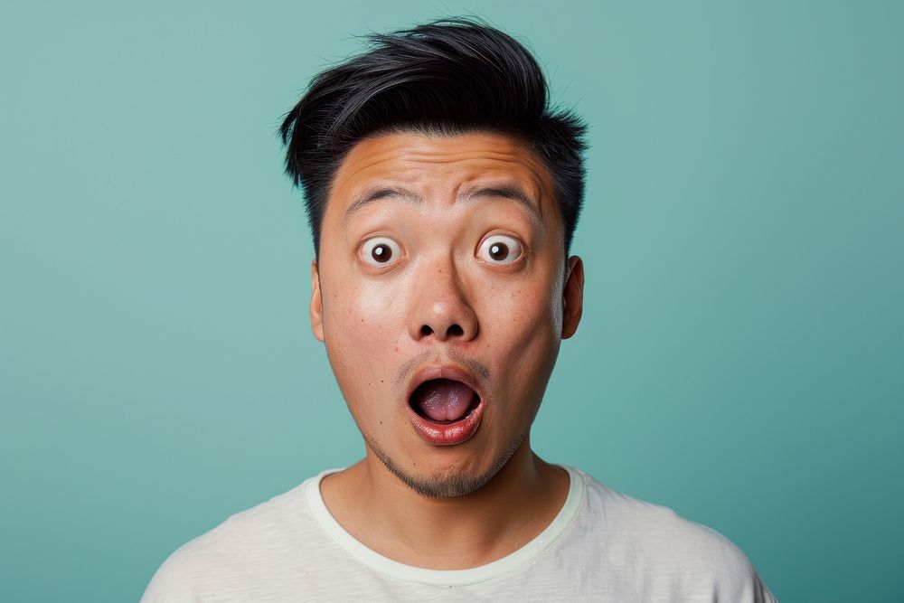Chinese man surprised face portrait adult frustration.