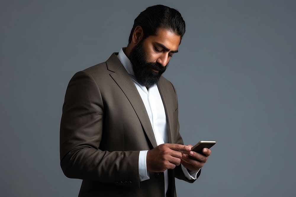 Indian businessman using phone portrait adult photo. AI generated Image by rawpixel.