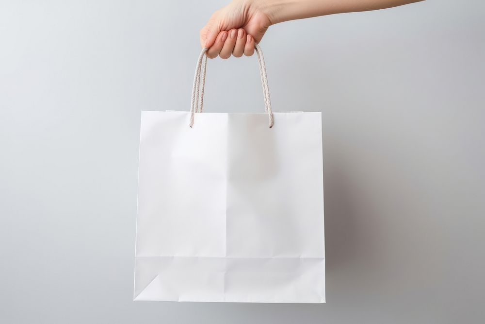 Paper shopping bag  handbag holding white.