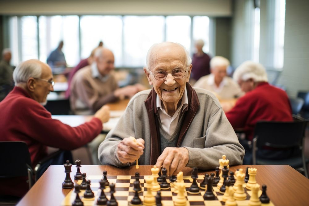 Group of seniors engaged in a lively game of chess at a community center adult men concentration. AI generated Image by…