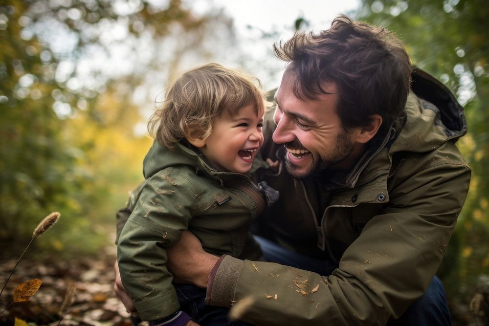 Father and child engaged in a playful activity or game outdoors laughing portrait bonding. AI generated Image by rawpixel.