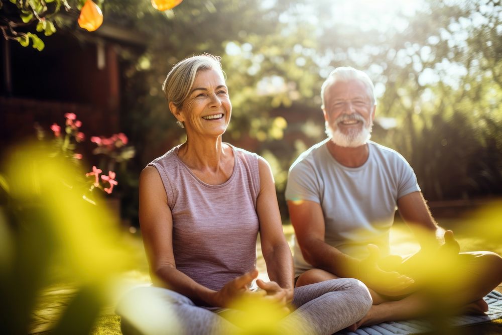 Senior couple smiling while practicing yoga together in a serene garden adult day togetherness. AI generated Image by…
