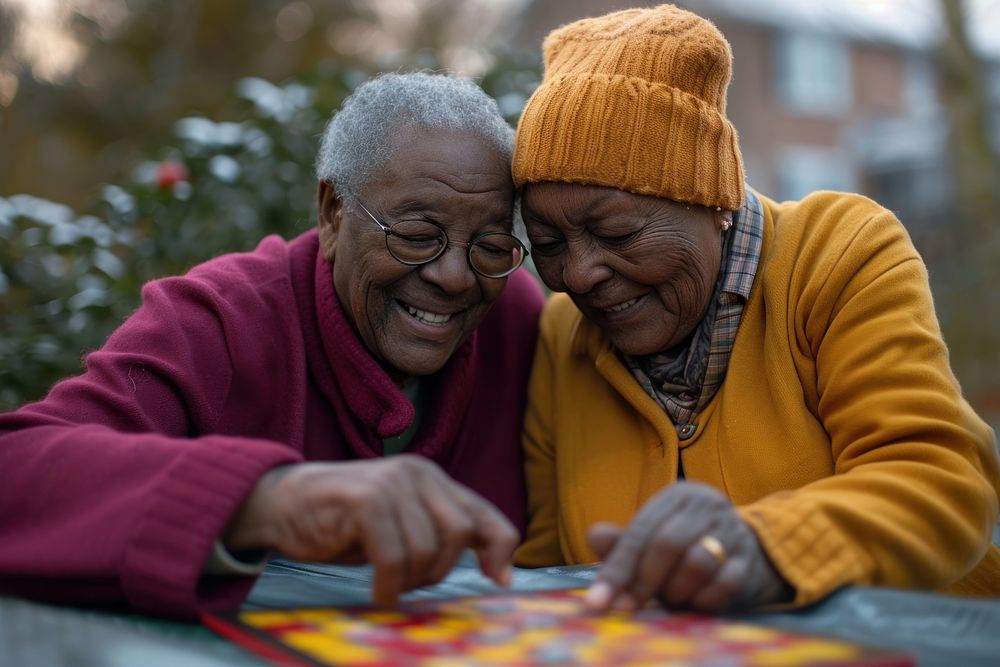 Black elderly couple engrossed in a board game adult art togetherness. AI generated Image by rawpixel.