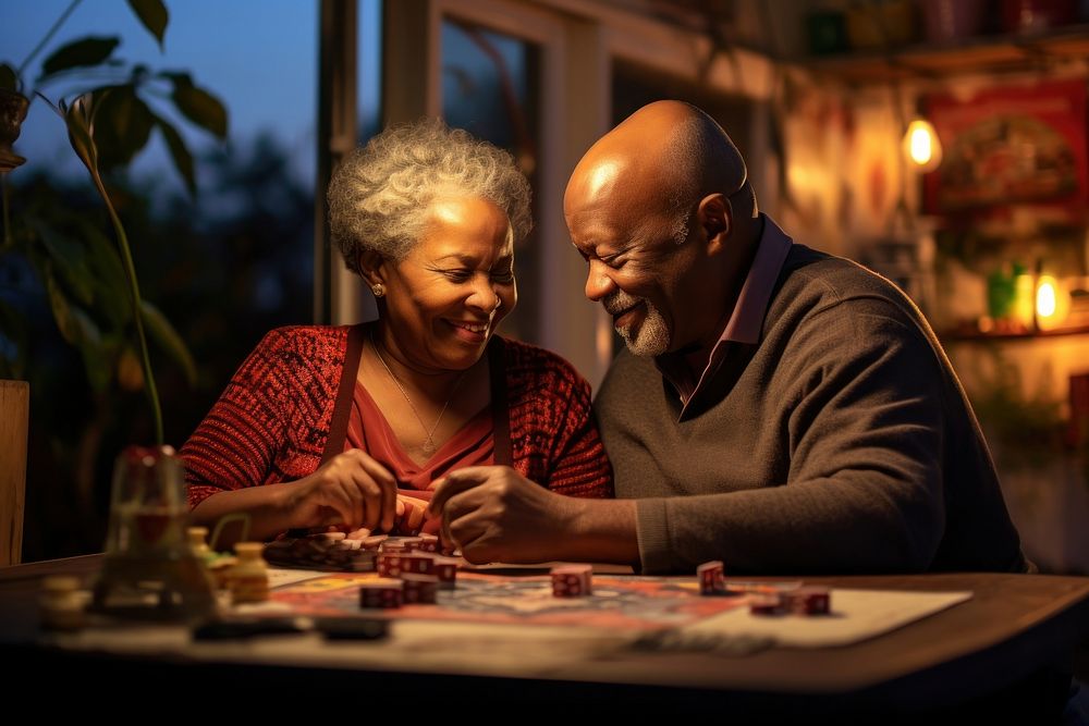 Black elderly couple engrossed in a board game gambling adult togetherness. AI generated Image by rawpixel.