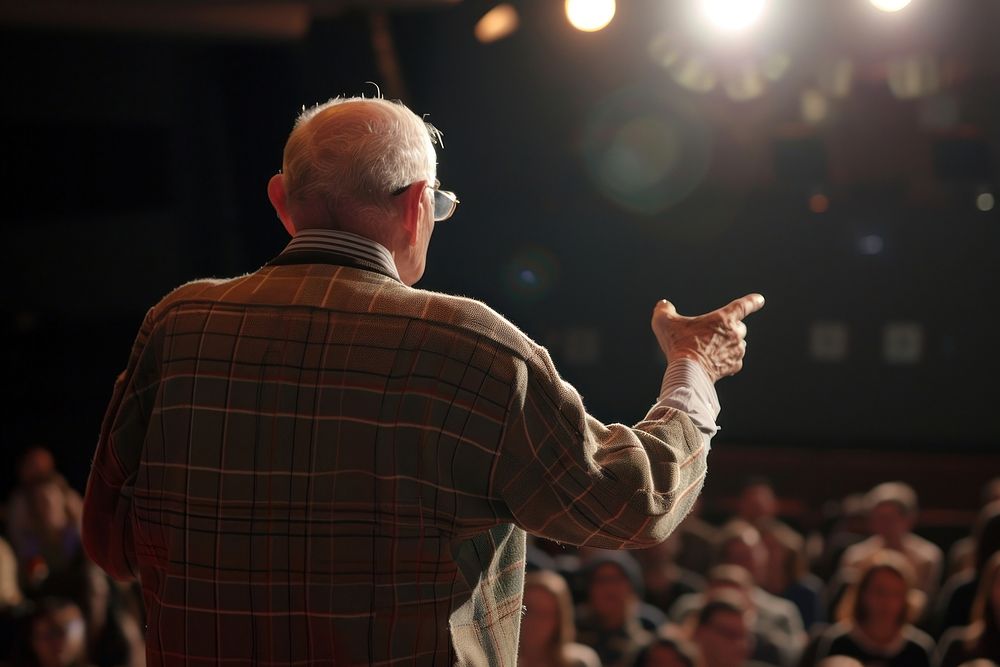Elderly gentleman giving a motivational speech at a community event audience lighting adult. AI generated Image by rawpixel.