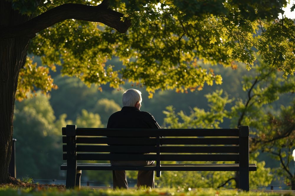 Elderly gentleman sitting on a park bench contemplation solitude adult. AI generated Image by rawpixel.