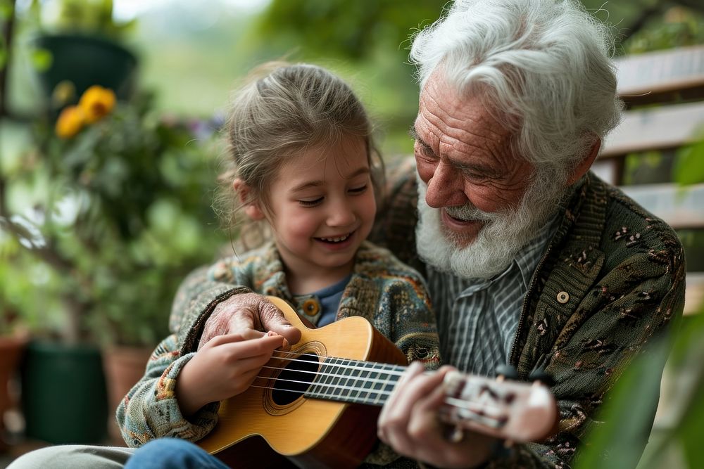 Elderly person teaching a grandchild to play a musical instrument musician bonding guitar. 