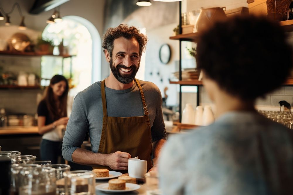 Coffee shop owner serving a coffee cup to customer smiling adult small business. AI generated Image by rawpixel.