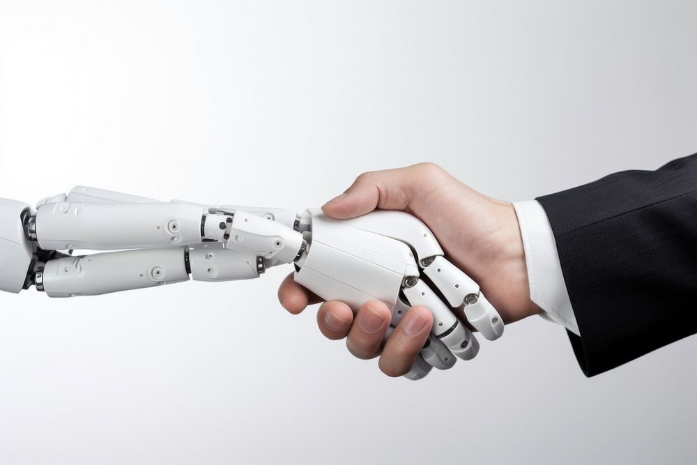 Robot hand shaking with human hand technology appliance machine.