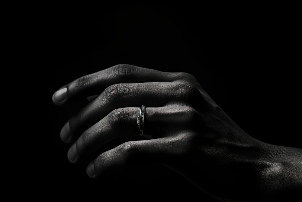Finger wearing ring black white hand.