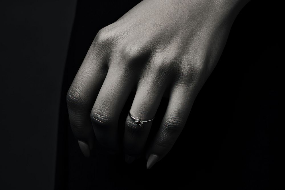 Finger wearing ring jewelry black hand.