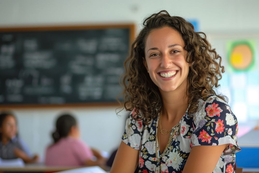 Woman teacher in front of classroom smiling adult smile.