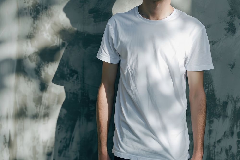 Man wearing t-shirt standing with clean concrete background sleeve white midsection.