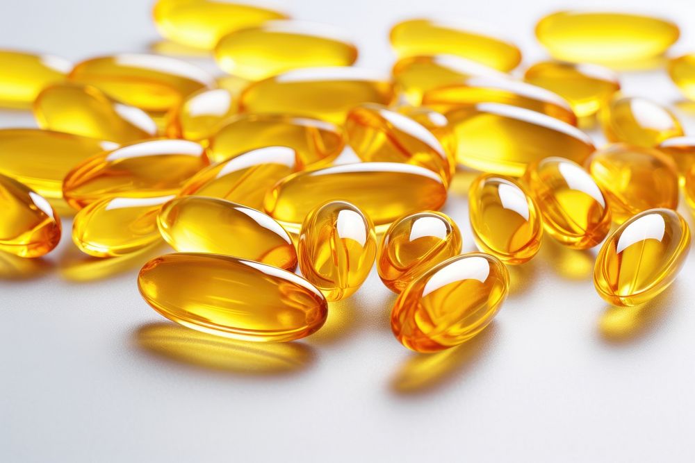 Fish oil capsules yellow pill medication.
