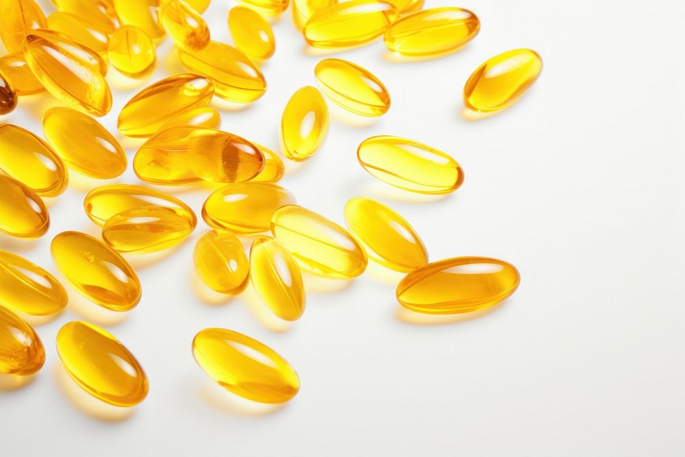 Fish oil capsules backgrounds yellow pill.