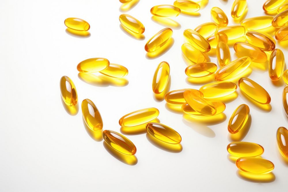 Fish oil capsules backgrounds yellow pill.