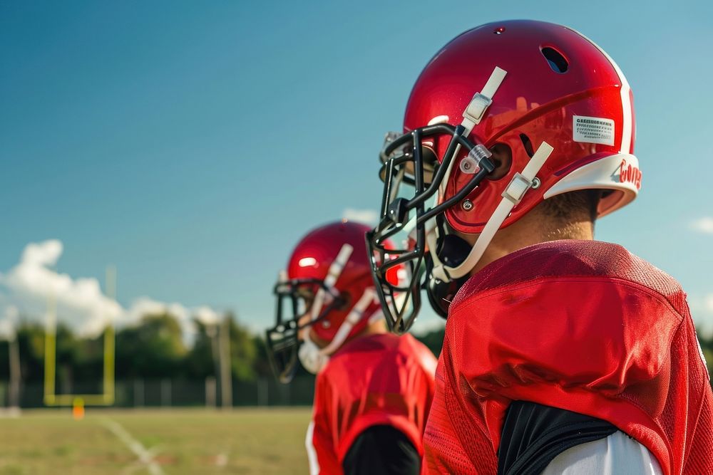 Two American footballers field helmet Free Photo rawpixel