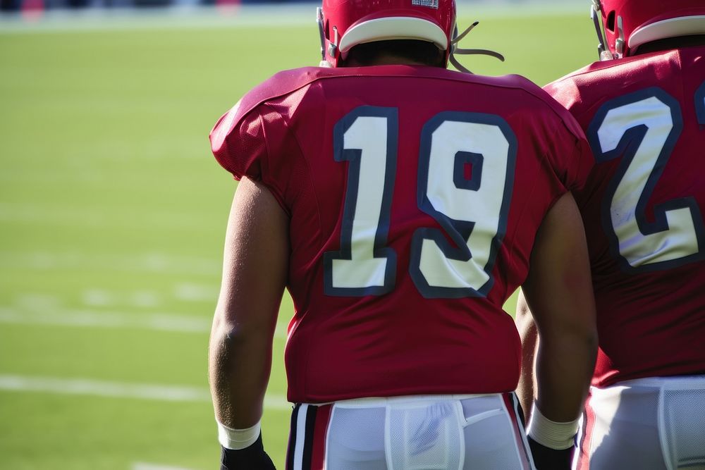 Two American footballers field helmet Free Photo rawpixel