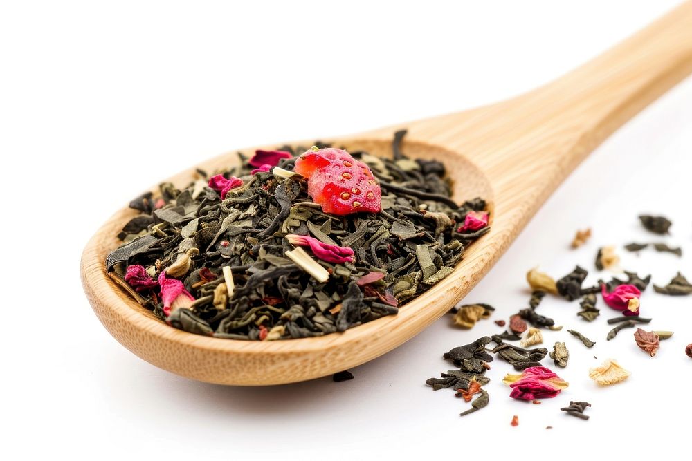 Mix of green tea with strawberry and hibiscus flowers drink plant spoon.