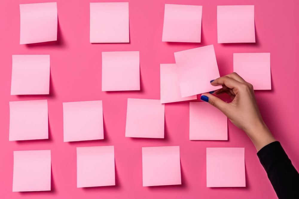 Female writing new ideas on sticky note paper organization backgrounds. AI generated Image by rawpixel.