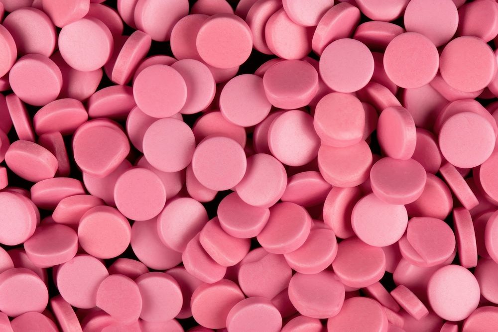 Macro Shot of Pink Pills During Production pill backgrounds pink. AI generated Image by rawpixel.