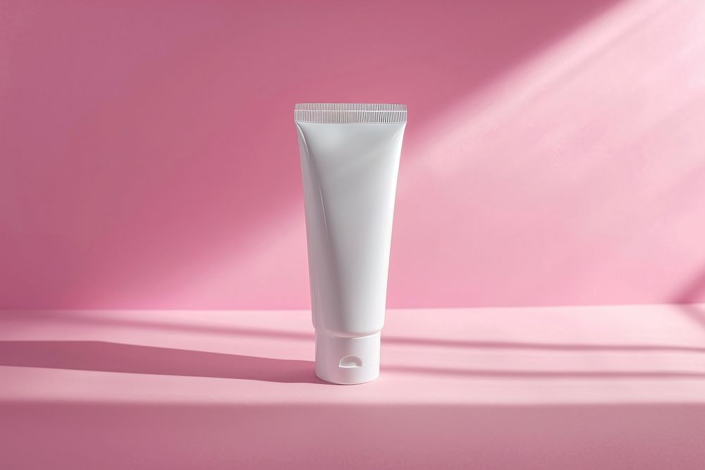 Handcream tube pink pink background toothpaste.